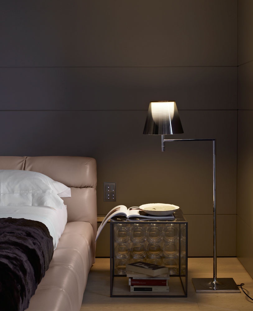 A coffee table on a steel base with a glass top Lens, B&B Italia