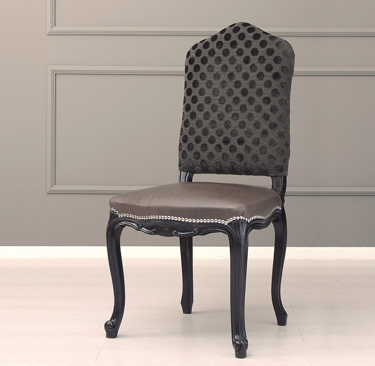 A chair on a frame of solid beech, upholstered in fabric and leather Mina Galimberti Nino