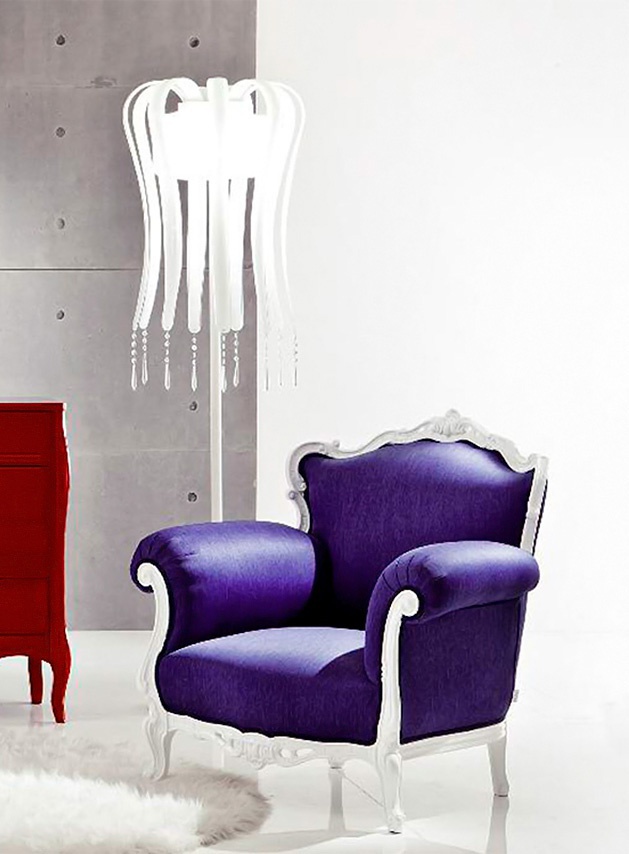 The high-backed chair on the carved frame has a Happy Hour Moda