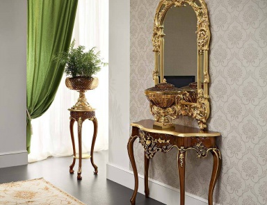 A wall mirror in a carved gilt frame Bella Vita Modenese Gastone