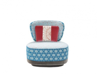 The Juju armchair is upholstered in fabric, Moroso