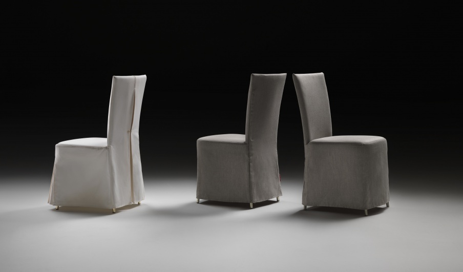 A chair with a high back on a metal frame Eva Flexform